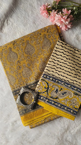 kota saree with a decorative bowl and pink flowers on a textured surface