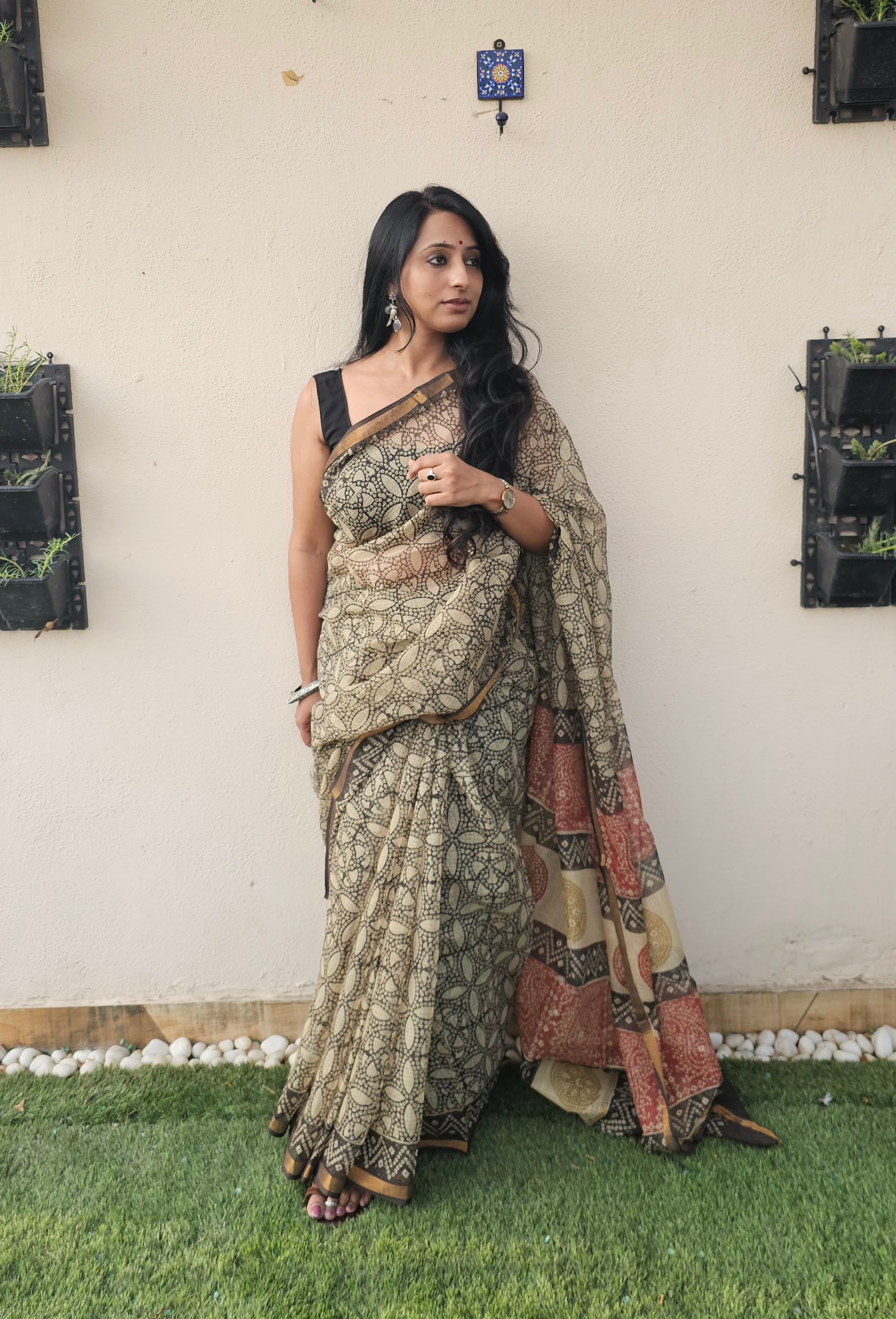 cream and black motif saree with intricate floral and geometrics patterns, featuring a multicolored pallu in earthy tones-handloom cotton.