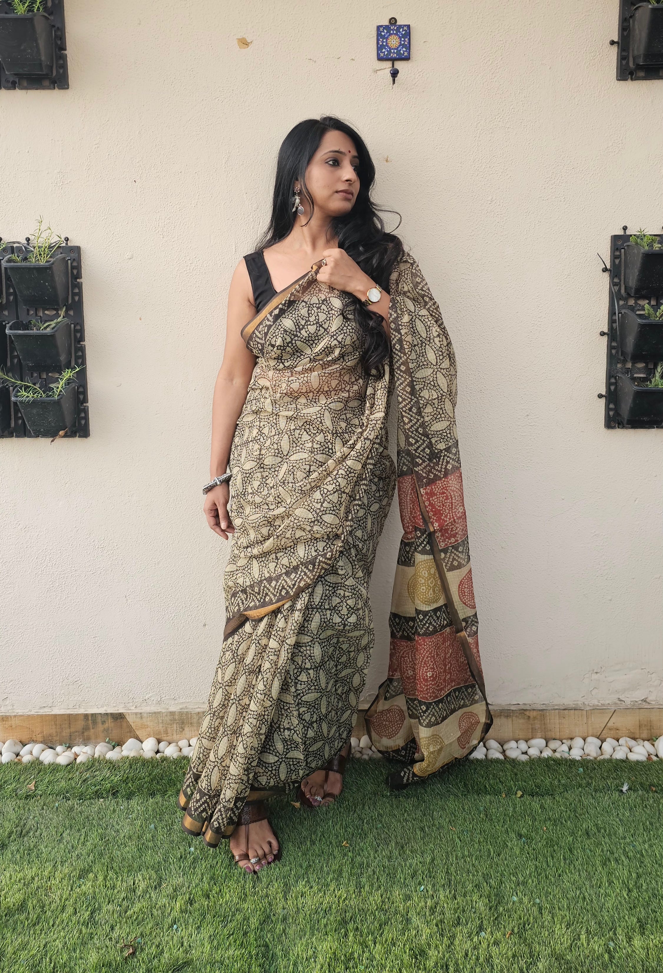 cream and black motif saree with intricate floral and geometrics patterns, featuring a multicolored pallu in earthy tones-handloom cotton.