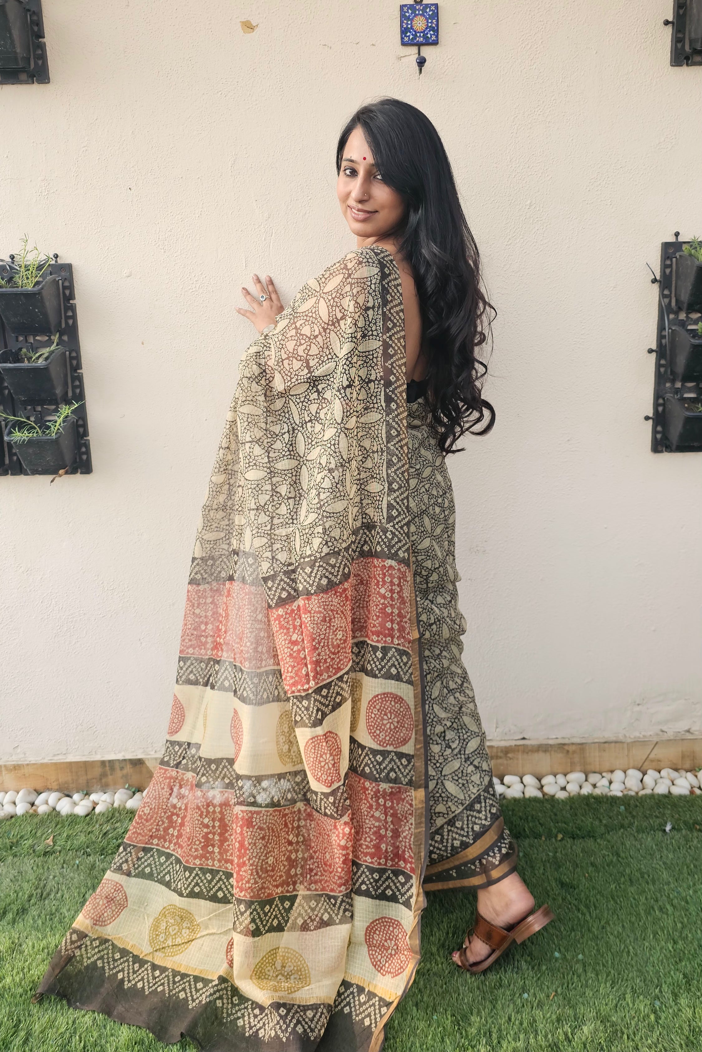 cream and black motif saree with intricate floral and geometrics patterns, featuring a multicolored pallu in earthy tones-handloom cotton.