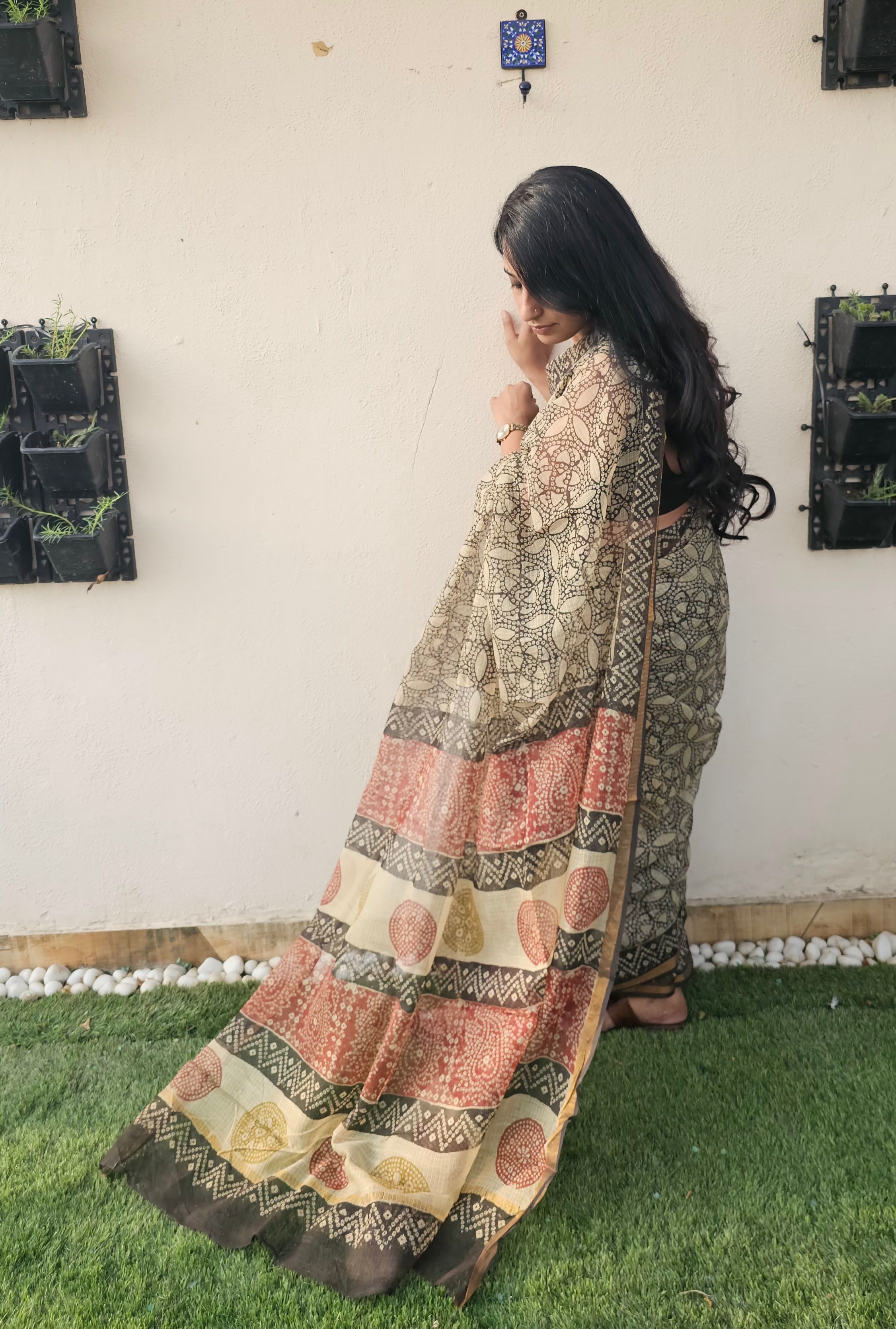 cream and black motif saree with intricate floral and geometrics patterns, featuring a multicolored pallu in earthy tones-handloom cotton.