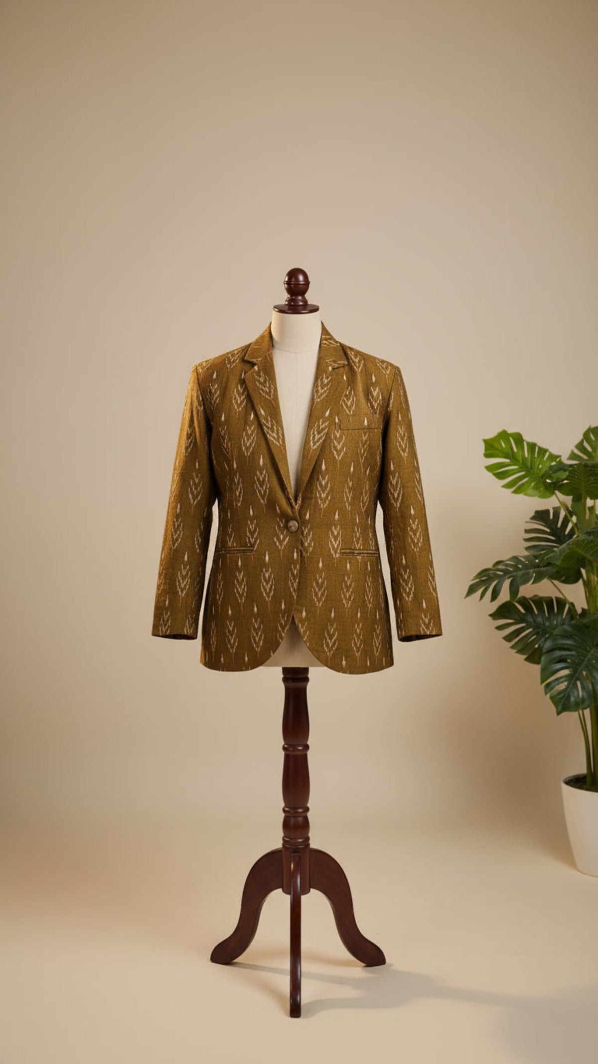 Brown patterned blazer on a wooden mannequin against a beige background
